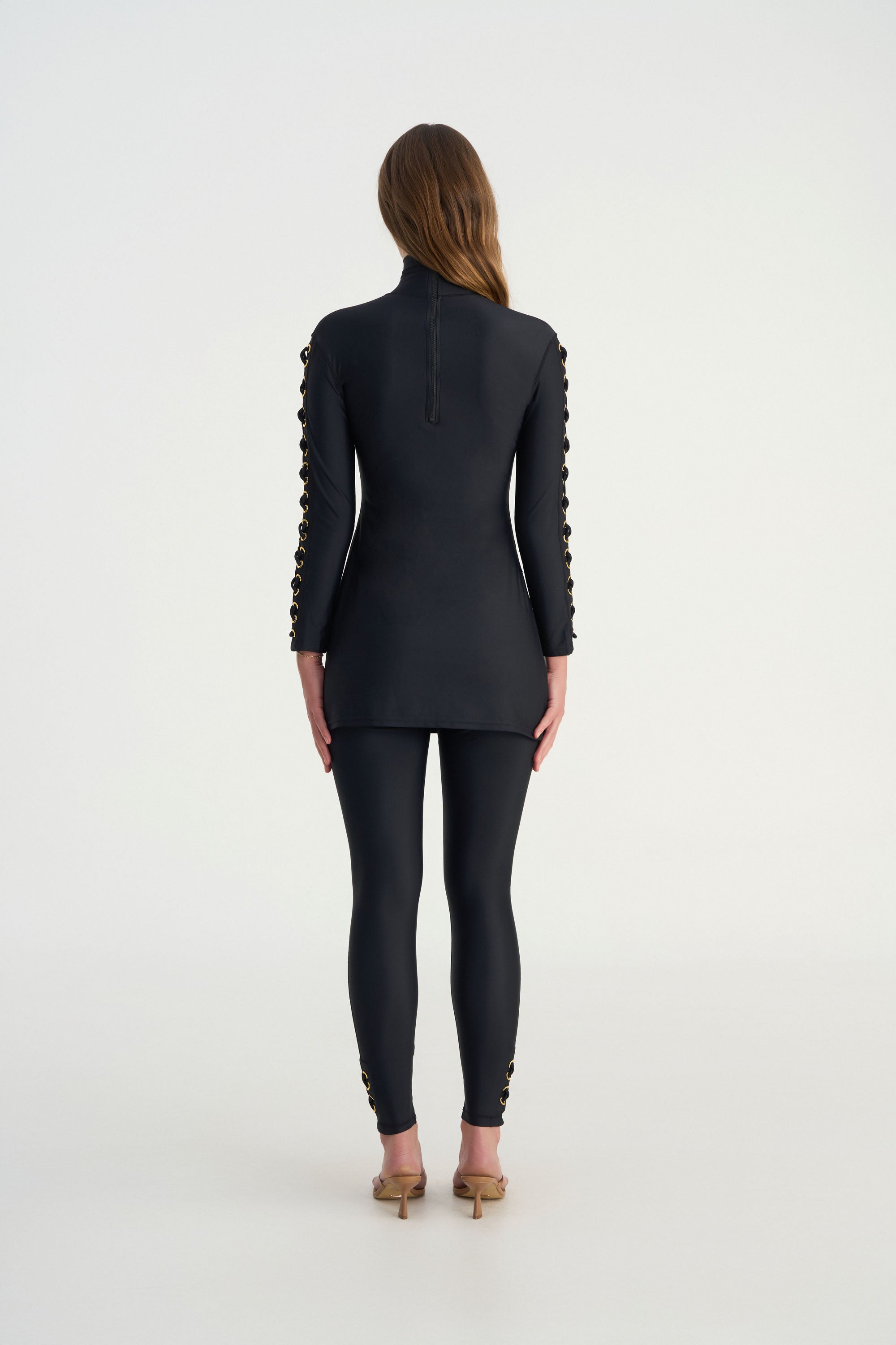 Back view of CEMILE black full coverage swim leggings with sculpting silhouette