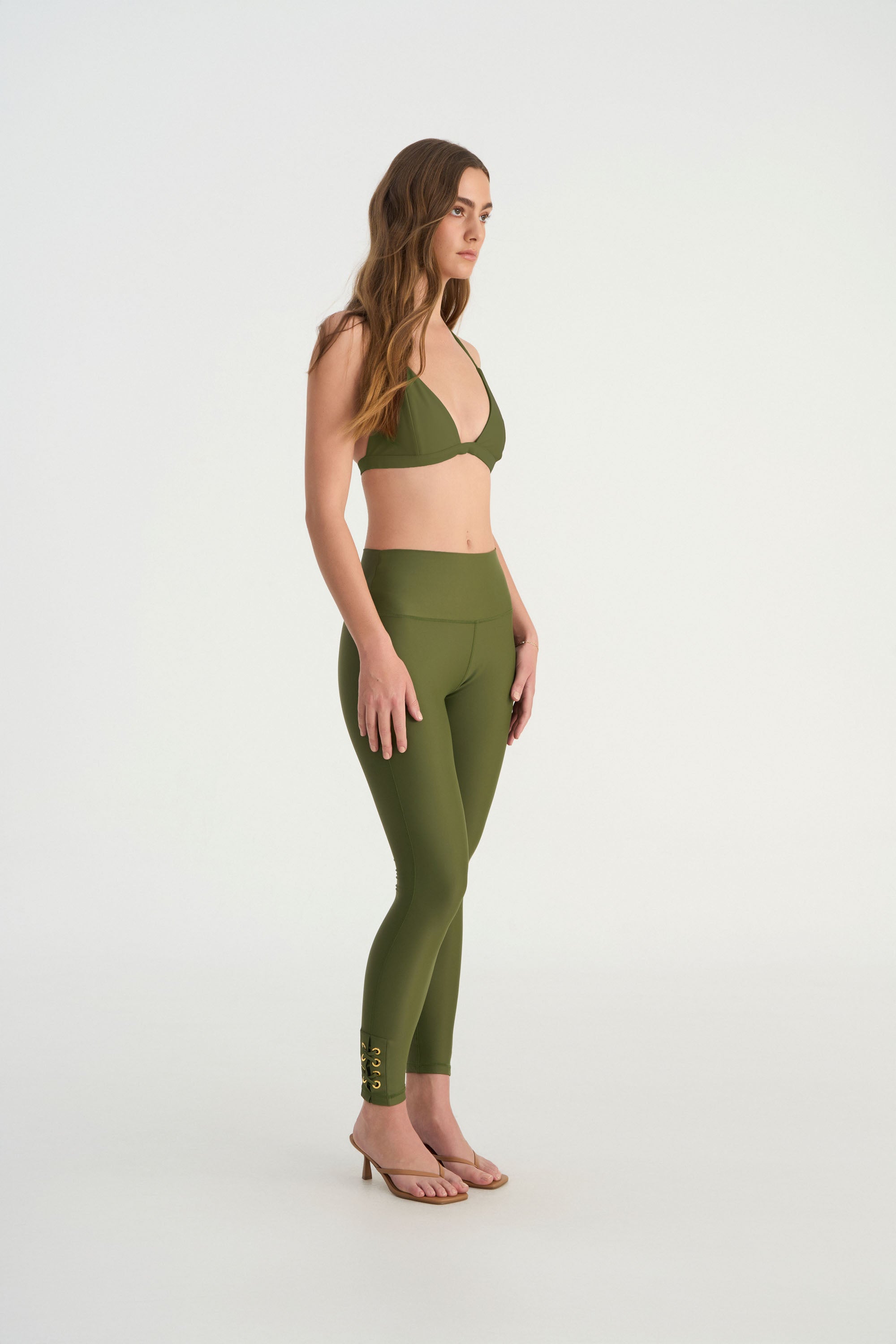 Side profile of CEMILE black modest swim leggings designed for resort wear and active movement background