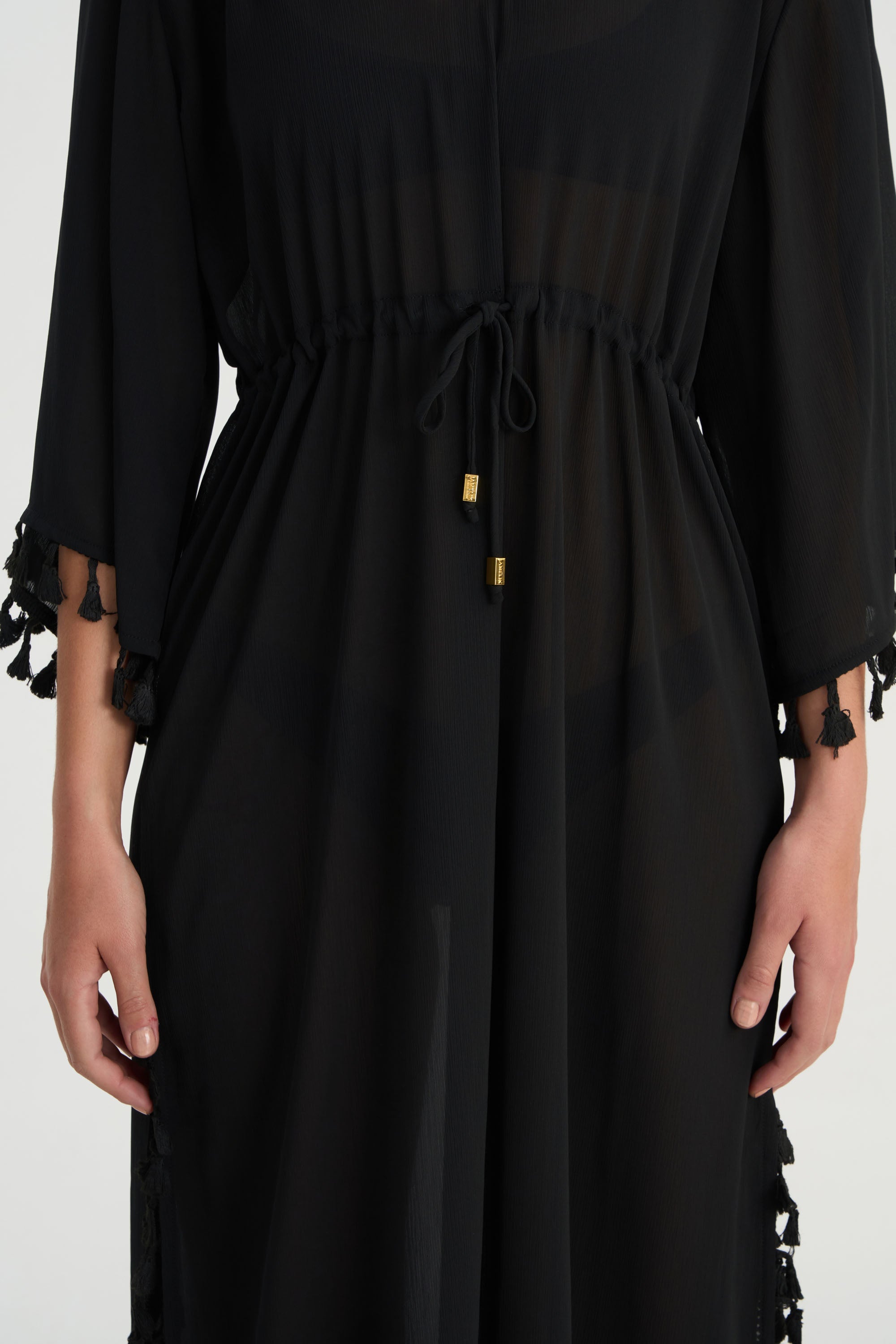 Handcrafted tassel detailing on the FLUER luxury V-neck kaftan