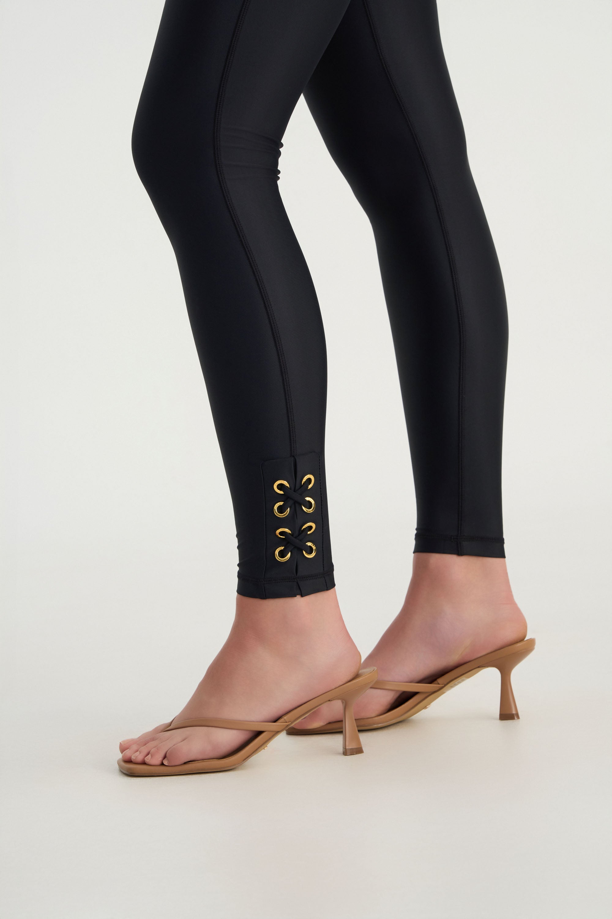 Hand-finished eyelet detailing on CEMILE black luxury swim leggings