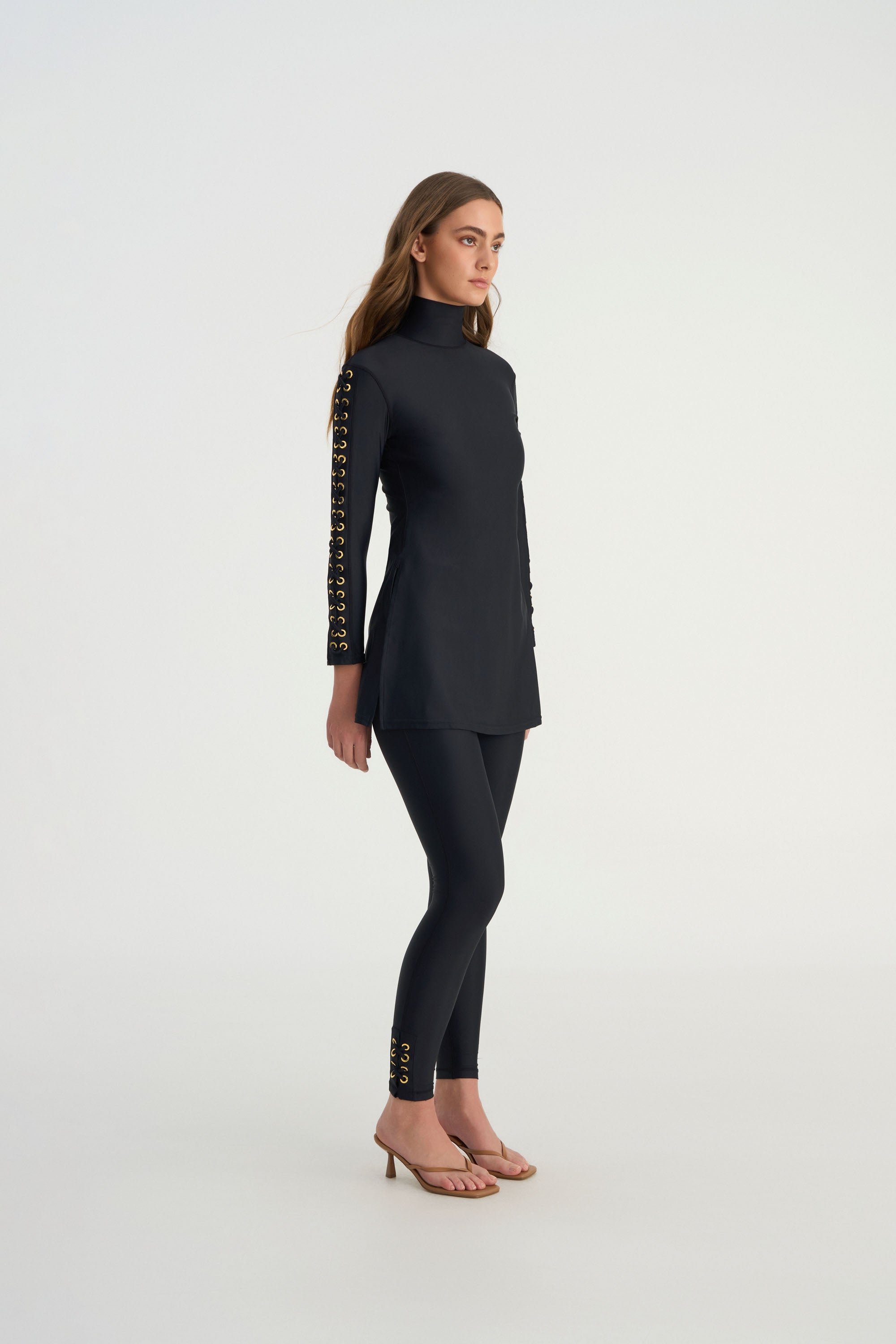 Side profile of CEMILE black modest swim leggings designed for resort wear and active movement