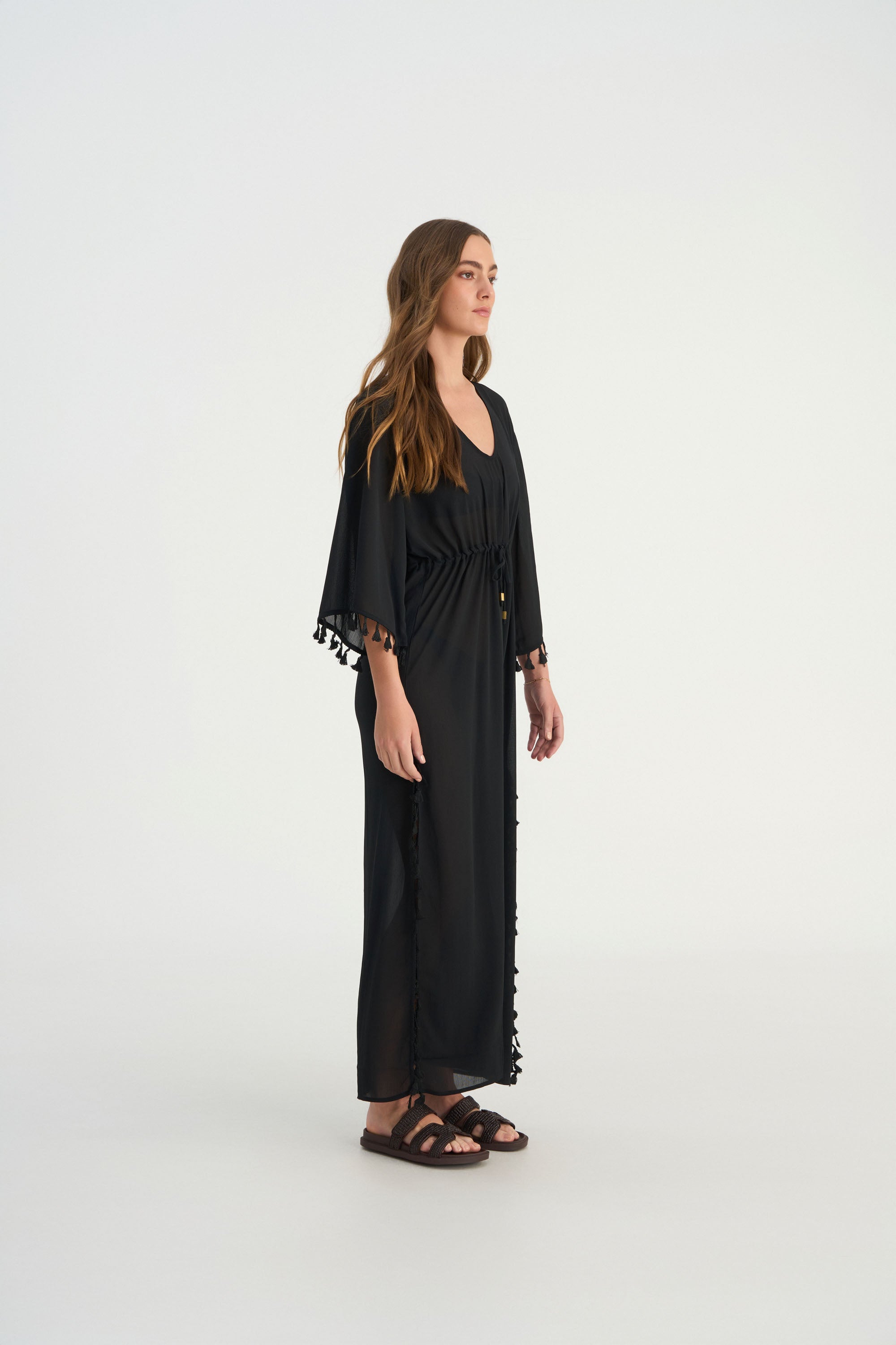 Handcrafted tassel detailing on the FLUER luxury V-neck kaftan