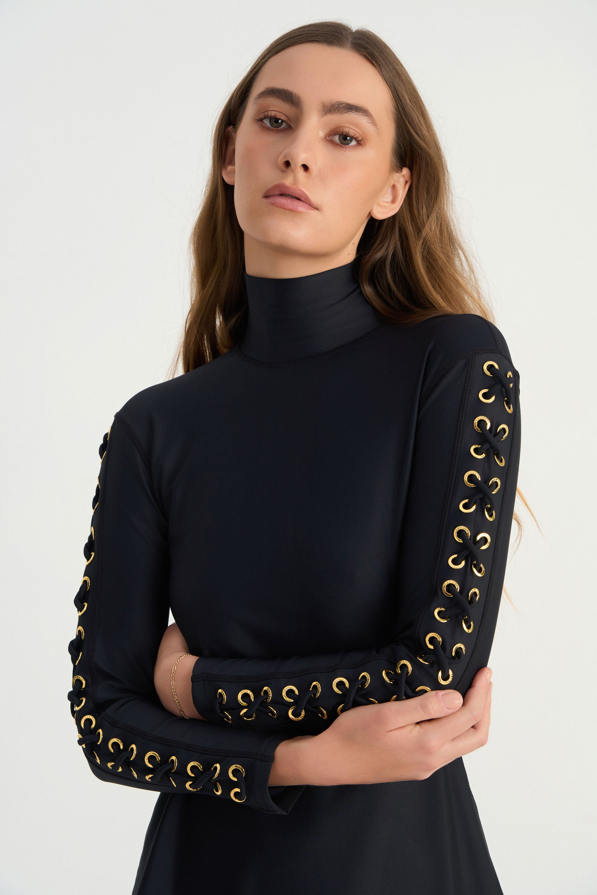 Hand-finished eyelet detailing on the sleeve of the JAMILA luxury swim tunic